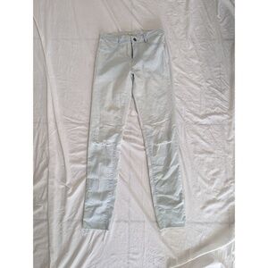 Light blue skinny jeans with knee rips